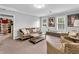 Cozy living room with wicker furniture, ample seating, and natural light from windows and door at 5625 Brookstone Nw Dr, Acworth, GA 30101