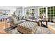 Spacious living room with large ottoman, stylish rug and view into an open kitchen at 5625 Brookstone Nw Dr, Acworth, GA 30101