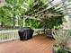 Relaxing outdoor deck area with pergola, grill, ceiling fan, and dining space at 5625 Brookstone Nw Dr, Acworth, GA 30101