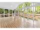 Bright sunroom with wood floors and expansive windows overlooking a lush backyard at 5625 Brookstone Nw Dr, Acworth, GA 30101