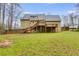 Expansive backyard featuring a two-story deck, backing up to a line of tall trees at 118 Hunters Pl, Villa Rica, GA 30180