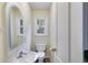 Cozy half bath with a white toilet, sink, and trim at 118 Hunters Pl, Villa Rica, GA 30180