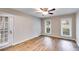 Bedroom with hardwood floors, a ceiling fan, and a door that leads to the exterior at 118 Hunters Pl, Villa Rica, GA 30180