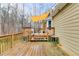 Spacious wooden deck with a yellow sunshade, ideal for outdoor relaxation and entertaining at 118 Hunters Pl, Villa Rica, GA 30180