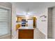 Well-lit kitchen with woodgrain wall decor, stainless steel appliances, and an island at 118 Hunters Pl, Villa Rica, GA 30180