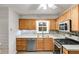 Charming kitchen featuring wood cabinets, a stylish backsplash, and stainless steel appliances at 118 Hunters Pl, Villa Rica, GA 30180