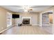 Spacious living room with light woodgrain floors, brick fireplace, and large windows at 118 Hunters Pl, Villa Rica, GA 30180