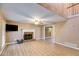 Cozy living room featuring a stone fireplace, high ceilings, and light woodgrain floors at 118 Hunters Pl, Villa Rica, GA 30180