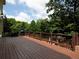 A spacious wooden deck provides the perfect outdoor living space with lush greenery surrounding it at 1205 Renaissance Se Ct, Mableton, GA 30126