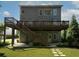 Large backyard with back porch and stairs leading to a lower level patio area at 1205 Renaissance Se Ct, Mableton, GA 30126
