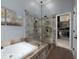 Spa-like bathroom with glass-enclosed shower, soaking tub, and access to a large walk-in closet at 1205 Renaissance Se Ct, Mableton, GA 30126