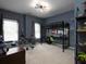 This cozy bedroom features neutral carpets, gray-blue walls, and a sleek black loft bed with study area at 1205 Renaissance Se Ct, Mableton, GA 30126