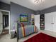 Well-lit bedroom with gray walls, comfortable bed, and convenient access to the bathroom and walk-in closet at 1205 Renaissance Se Ct, Mableton, GA 30126