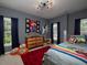 Whimsical bedroom featuring colorful decor, and large windows providing ample natural light at 1205 Renaissance Se Ct, Mableton, GA 30126