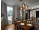 Elegant dining room with modern lighting, a spacious table, and hardwood floors at 1205 Renaissance Se Ct, Mableton, GA 30126