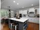 Beautiful kitchen with white cabinetry, gray island with barstool seating, and modern appliances at 1205 Renaissance Se Ct, Mableton, GA 30126