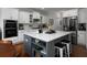 Modern kitchen with white cabinets, marble countertops, stainless steel appliances, and a gray island at 1205 Renaissance Se Ct, Mableton, GA 30126