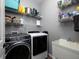 This functional laundry room features a modern washer and dryer, along with ample shelving at 1205 Renaissance Se Ct, Mableton, GA 30126