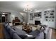 Inviting living room featuring a fireplace, built-in shelves, hardwood floors, and view of the staircase at 1205 Renaissance Se Ct, Mableton, GA 30126