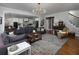 Open-concept living room with hardwood floors and seamless flow into a modern kitchen with an island at 1205 Renaissance Se Ct, Mableton, GA 30126