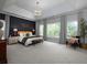 Spacious main bedroom featuring a decorative accent wall, tray ceiling and large windows at 1205 Renaissance Se Ct, Mableton, GA 30126