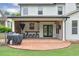 Home's backyard has a covered patio, outdoor kitchen and plenty of grass at 134 Johnston Farm Ln, Woodstock, GA 30188