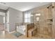 Bathroom features a tiled shower with glass door and a soaking tub by the window at 134 Johnston Farm Ln, Woodstock, GA 30188
