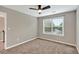 Bedroom features a large window with blinds, neutral colored walls, and carpeted floors at 134 Johnston Farm Ln, Woodstock, GA 30188