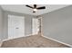 Neutral bedroom featuring carpet, ceiling fan, and a closet with double doors at 134 Johnston Farm Ln, Woodstock, GA 30188