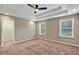 Bedroom featuring two windows and a doorway into a walk-in closet with white shelving at 134 Johnston Farm Ln, Woodstock, GA 30188