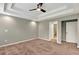 Bedroom with recessed lighting, fan, carpeted floors, and doorways to the bathroom and closet at 134 Johnston Farm Ln, Woodstock, GA 30188
