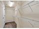 Walk in closet features white shelving, neutral colored walls and carpeted floors at 134 Johnston Farm Ln, Woodstock, GA 30188