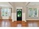 Bright foyer with hardwood floors, black front door, and plenty of natural light at 134 Johnston Farm Ln, Woodstock, GA 30188