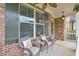 Inviting front porch with chairs and table; perfect for relaxing outdoors at 134 Johnston Farm Ln, Woodstock, GA 30188