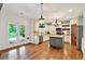 Spacious kitchen with white cabinetry, stainless appliances, and access to the backyard at 134 Johnston Farm Ln, Woodstock, GA 30188
