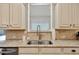 Close-up of a kitchen sink with granite countertops and stylish backsplash at 134 Johnston Farm Ln, Woodstock, GA 30188
