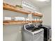 Bright laundry room with modern washer/dryer and rustic wood shelving at 134 Johnston Farm Ln, Woodstock, GA 30188