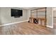 Entertainment room with wood-look flooring and built-in cabinet with shelving at 134 Johnston Farm Ln, Woodstock, GA 30188