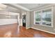 Spacious living room featuring hardwood floors and large windows for ample light at 134 Johnston Farm Ln, Woodstock, GA 30188
