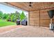 Covered outdoor patio with a wood ceiling, privacy screen, and outdoor kitchen at 134 Johnston Farm Ln, Woodstock, GA 30188