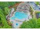 Stunning aerial view of the community pool and amenities, including a slide and sunbathing area at 134 Johnston Farm Ln, Woodstock, GA 30188