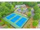Aerial view of tennis courts with manicured landscaping and surrounded by mature trees at 134 Johnston Farm Ln, Woodstock, GA 30188
