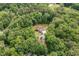 Drone shot of secluded home surrounded by mature trees on the property at 1825 Epperson Rd, Canton, GA 30115