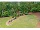 Aerial view of lush backyard featuring mature trees and green grass at 1825 Epperson Rd, Canton, GA 30115
