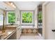 Bathroom featuring a soaking tub, double vanity, and a separate glass enclosed shower at 1825 Epperson Rd, Canton, GA 30115