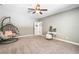 Cozy bedroom showcasing a hanging chair, desk, and plush decor for relaxation at 1825 Epperson Rd, Canton, GA 30115