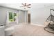 Bright bedroom featuring a ceiling fan, a large window, and a hanging chair at 1825 Epperson Rd, Canton, GA 30115