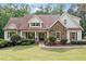 Charming home featuring a stone facade, wood shutters, and a covered front porch at 1825 Epperson Rd, Canton, GA 30115