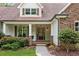 Inviting covered front porch with stone detail, seating, and elegant entry door at 1825 Epperson Rd, Canton, GA 30115