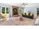 Cozy living room features a stone fireplace, ceiling fan and plush seating at 1825 Epperson Rd, Canton, GA 30115
